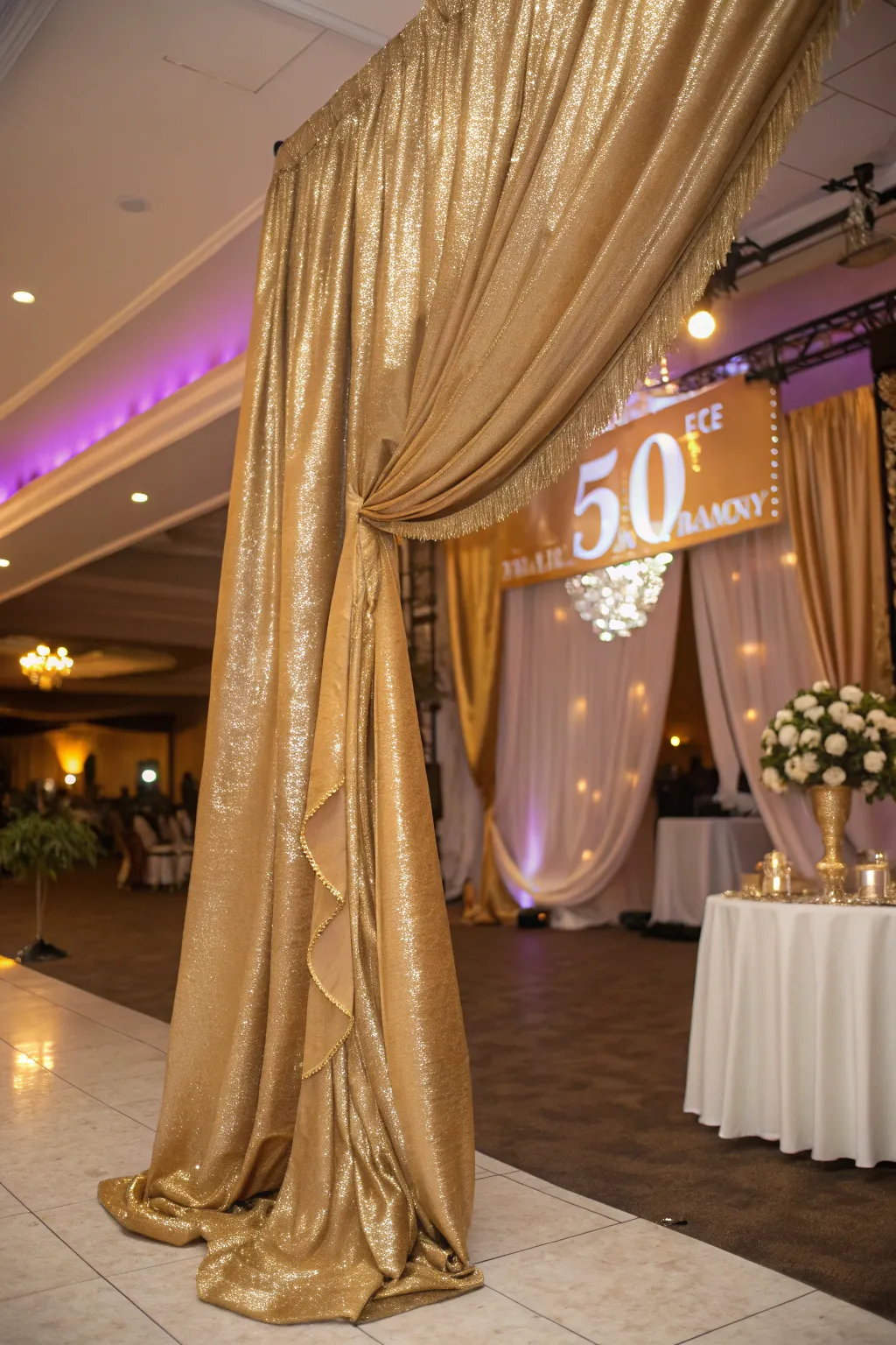 Luxurious gold satin drapery adding opulence to the celebration.