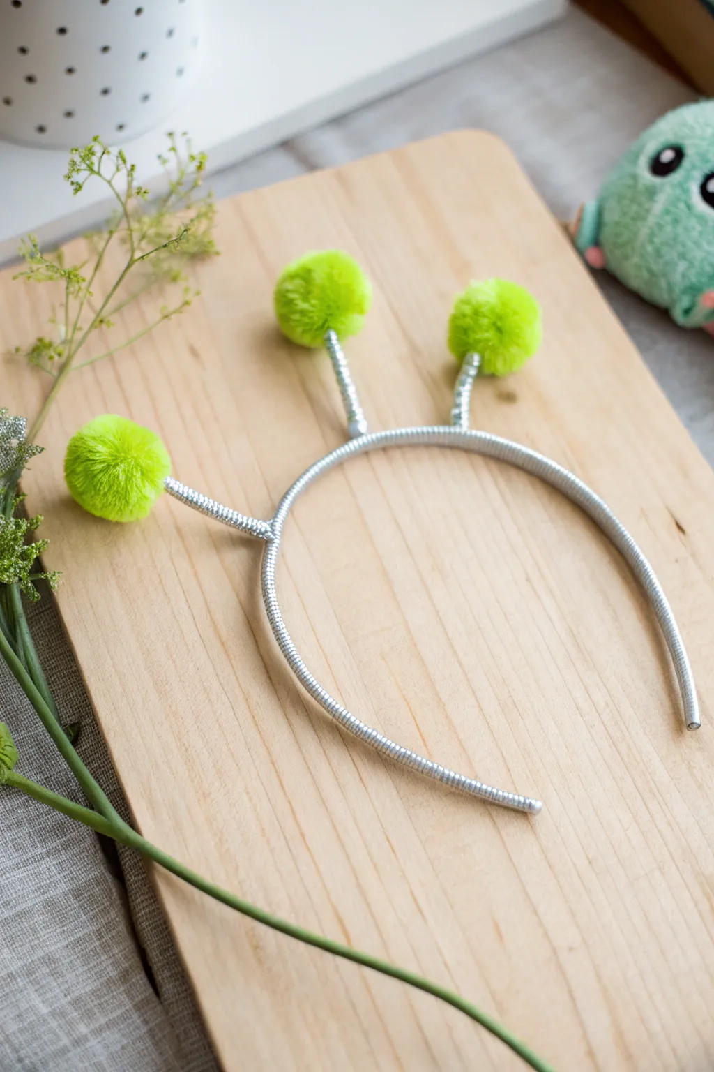 Elevate your alien-themed party with these charming DIY headbands, blending minimalist design with playful whimsy.