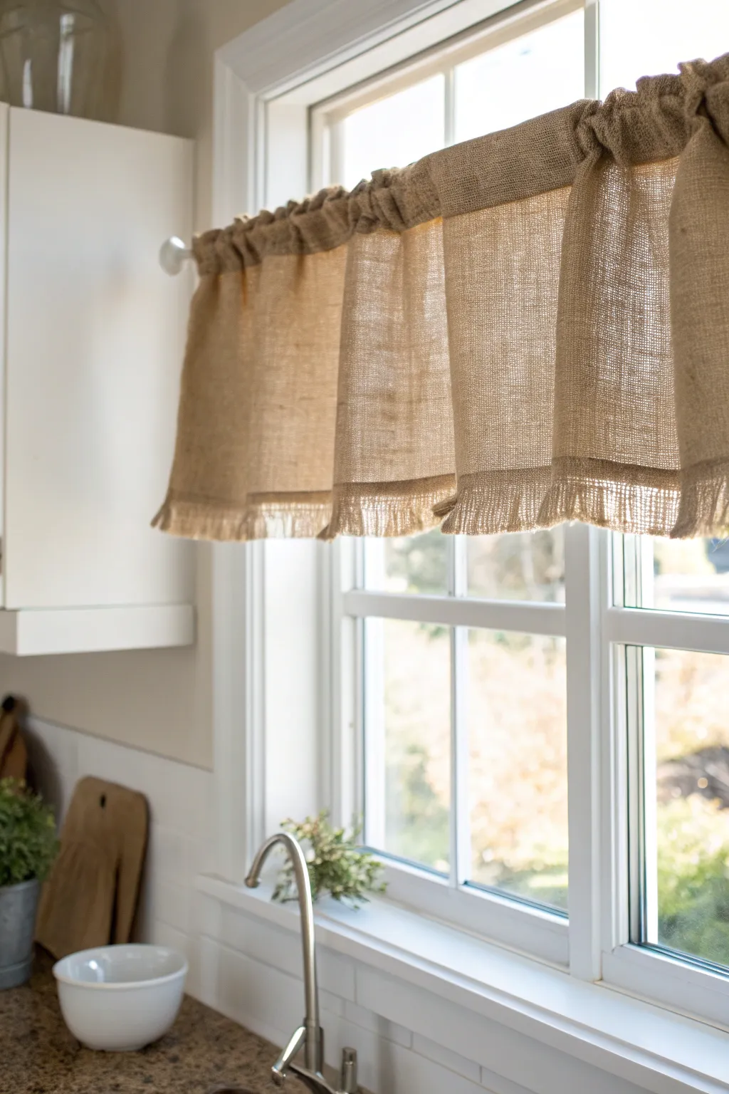 Bring nature indoors with this charming burlap valance, perfect for adding rustic elegance to your kitchen space.