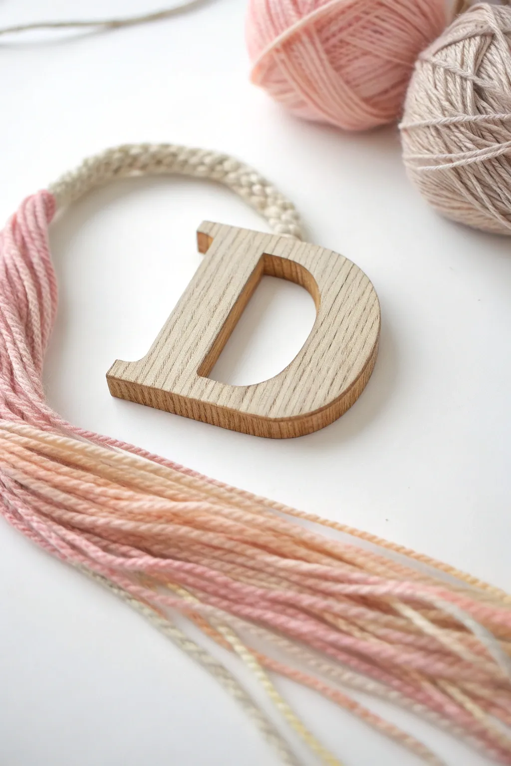 Discover the art of tactile learning with a minimalist yarn-wrapped 'D'.