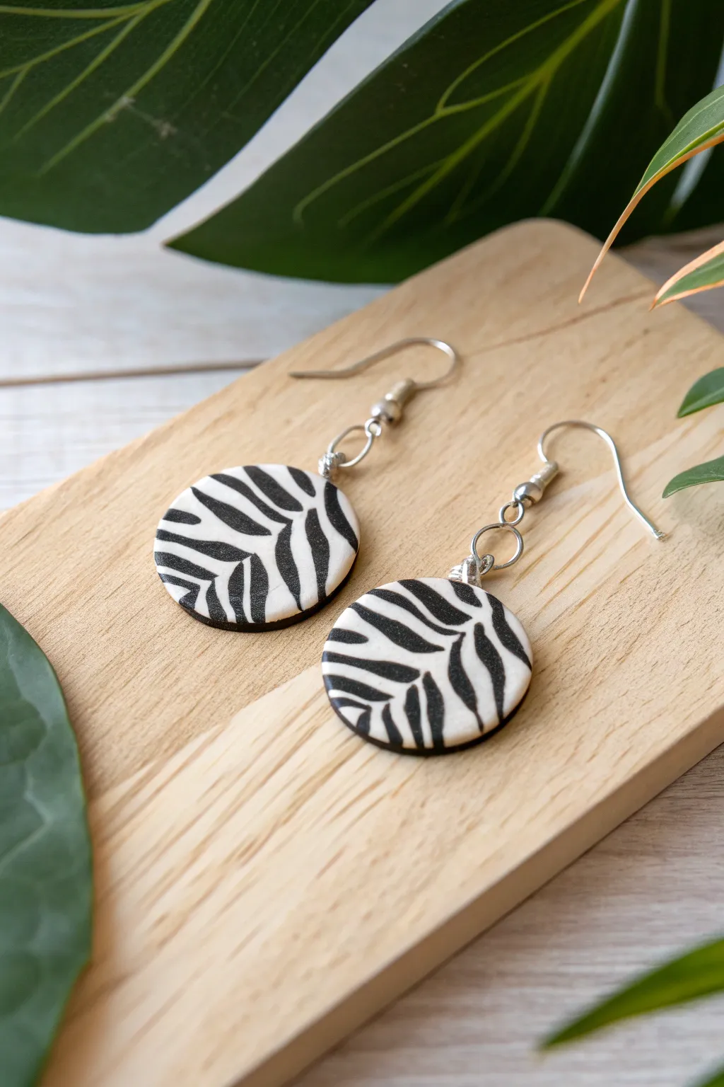 Unleash your wild side with these chic zebra stripe polymer clay earrings. Perfect for adding an edgy flair to any outfit!