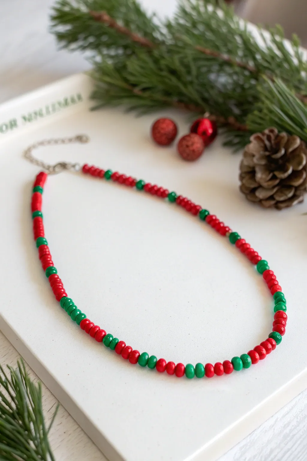 Embrace the holiday spirit with minimalist charm - a handcrafted pony bead necklace in festive hues.