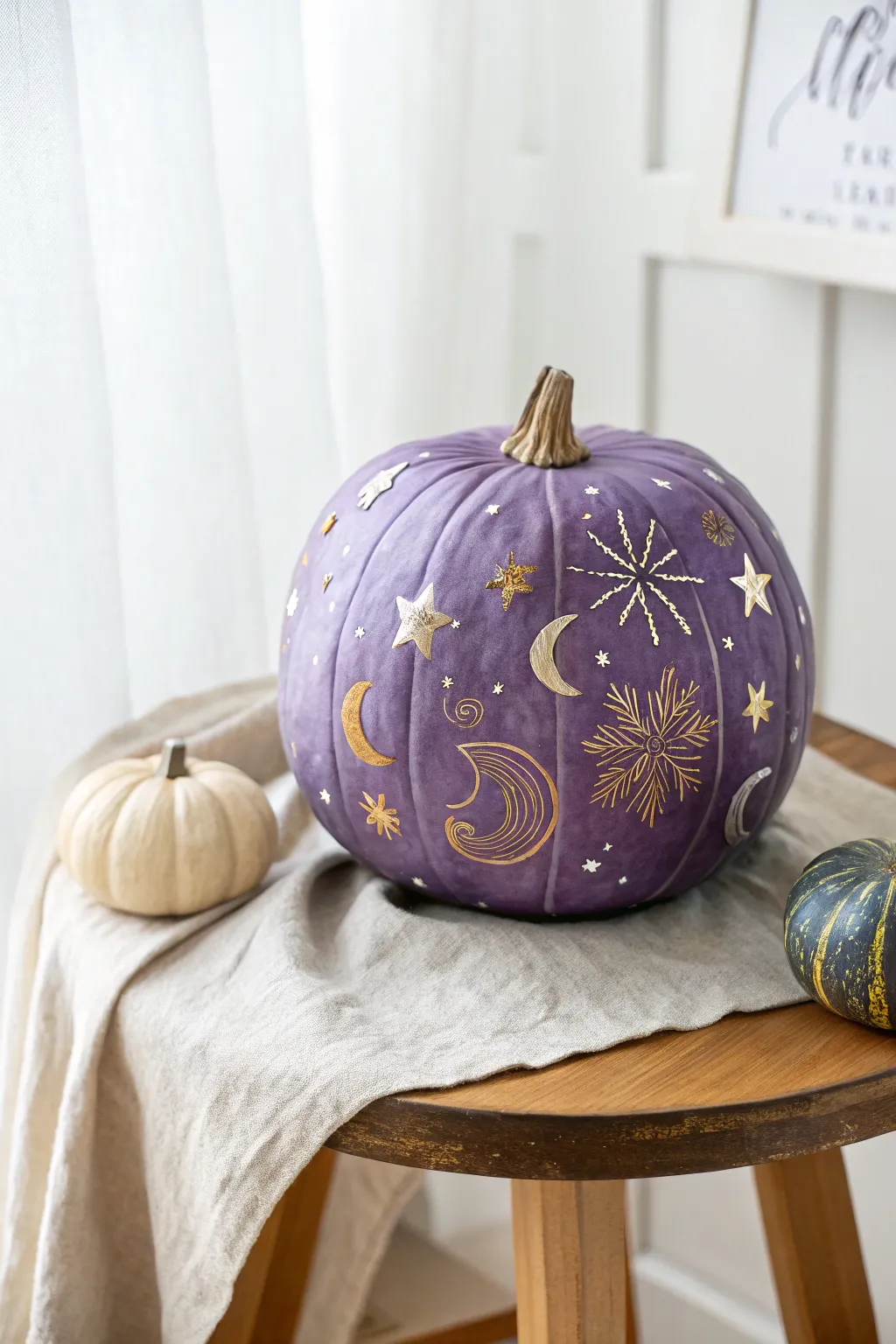 Enchant your autumn decor with celestial charm: a purple pumpkin adorned with stars and moons.