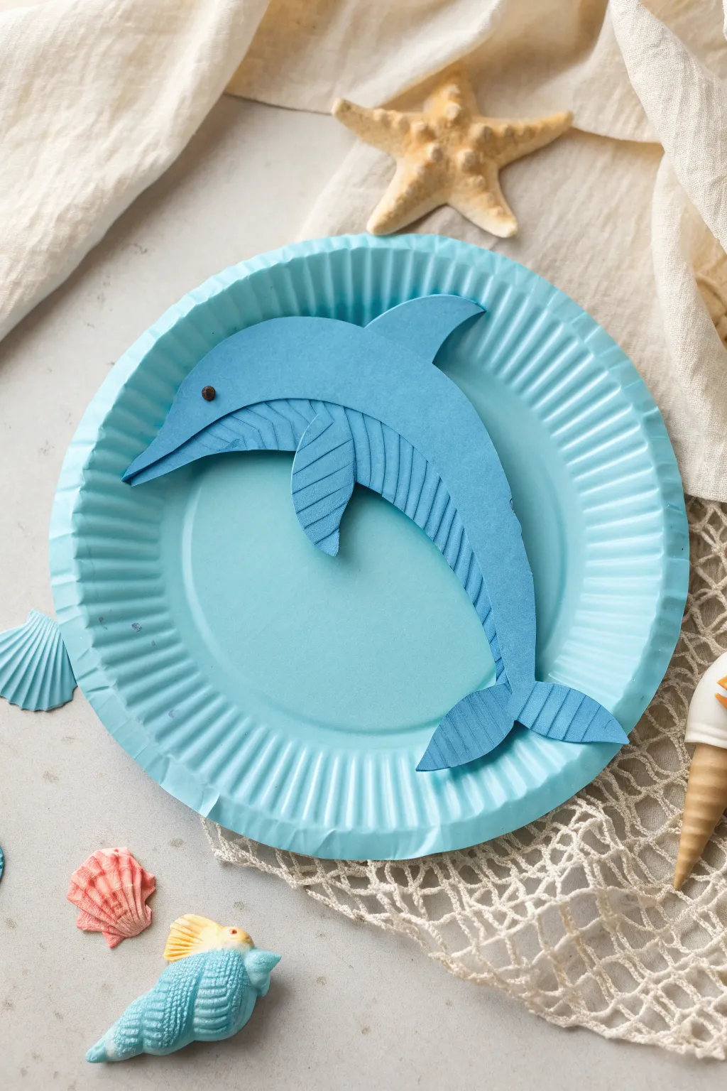 Dive into the joy of crafting with this charming paper plate dolphin!