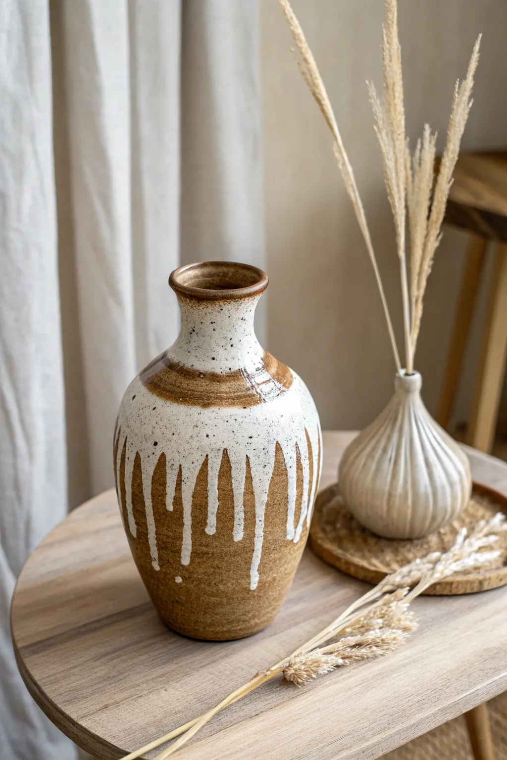 Embrace the beauty of simplicity with a rustic drip glaze on handcrafted pottery.