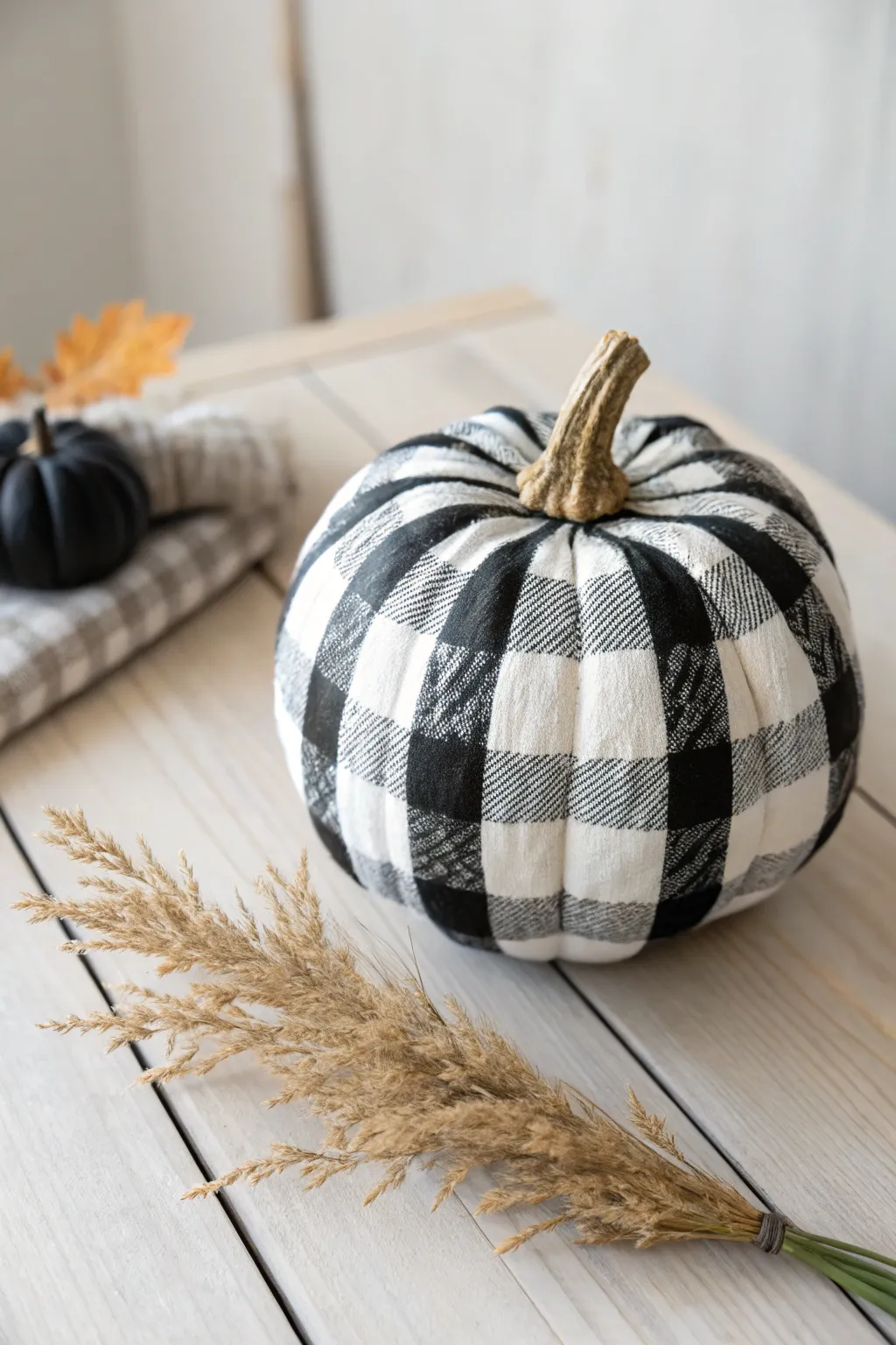 Wrap your pumpkin in cozy elegance with this buffalo plaid design, perfect for a minimalist autumn touch.
