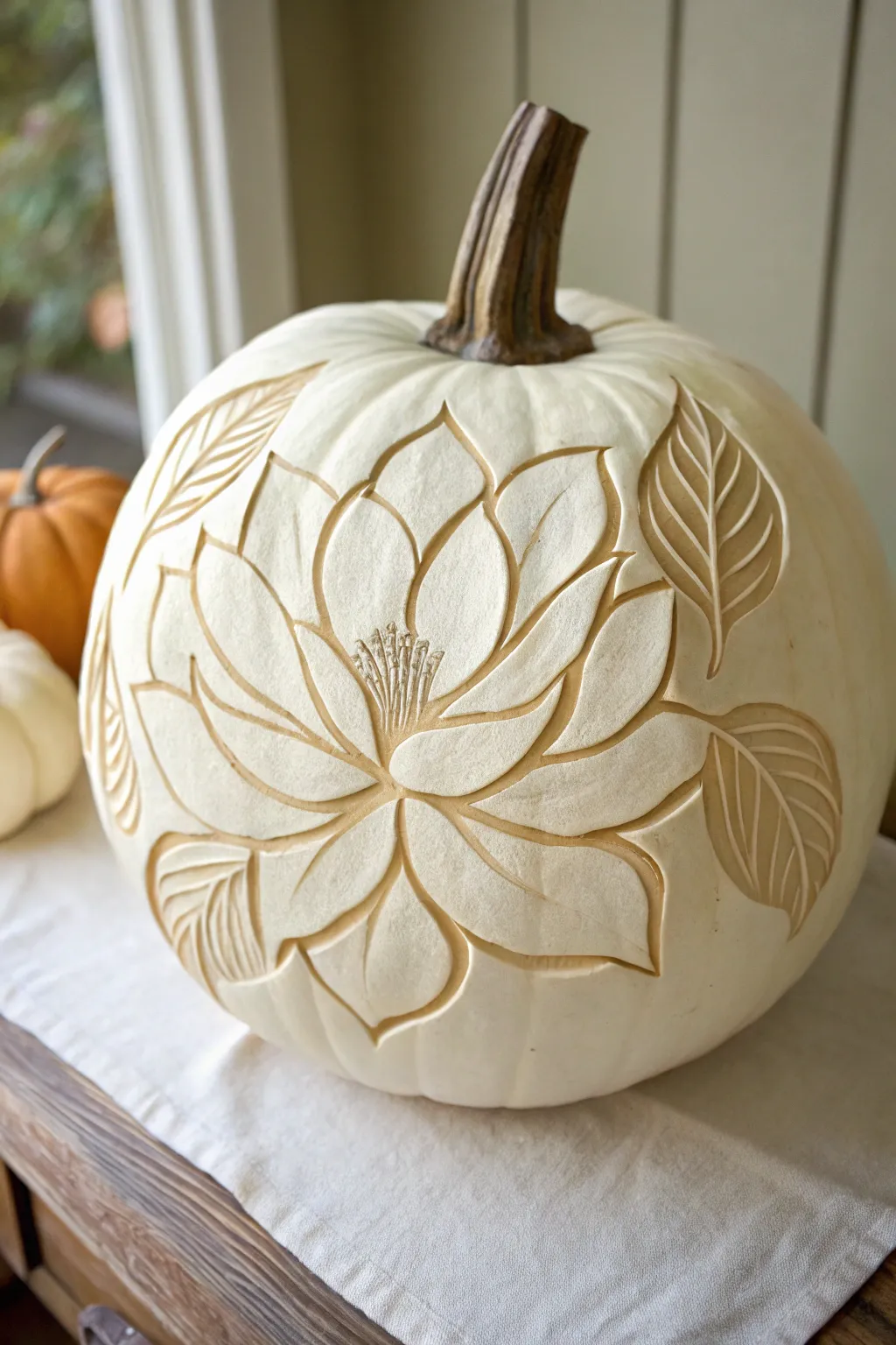 Embrace the elegance of fall with a Magnolia Majesty pumpkin carving, where simplicity meets natural beauty.