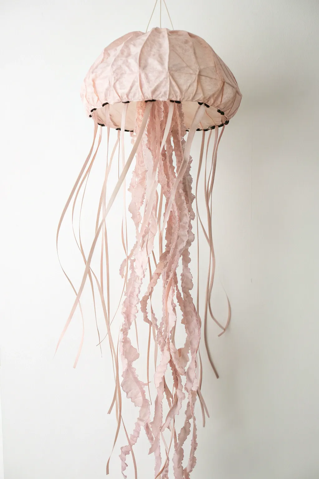 Cherish the simplicity and beauty of handmade memories with this enchanting handprint jellyfish keepsake.
