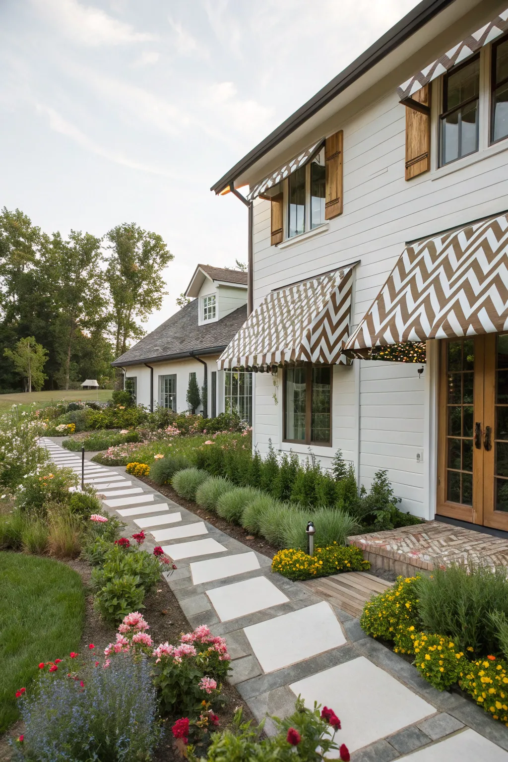 Chevron pattern awnings bring a modern twist to this farmhouse.