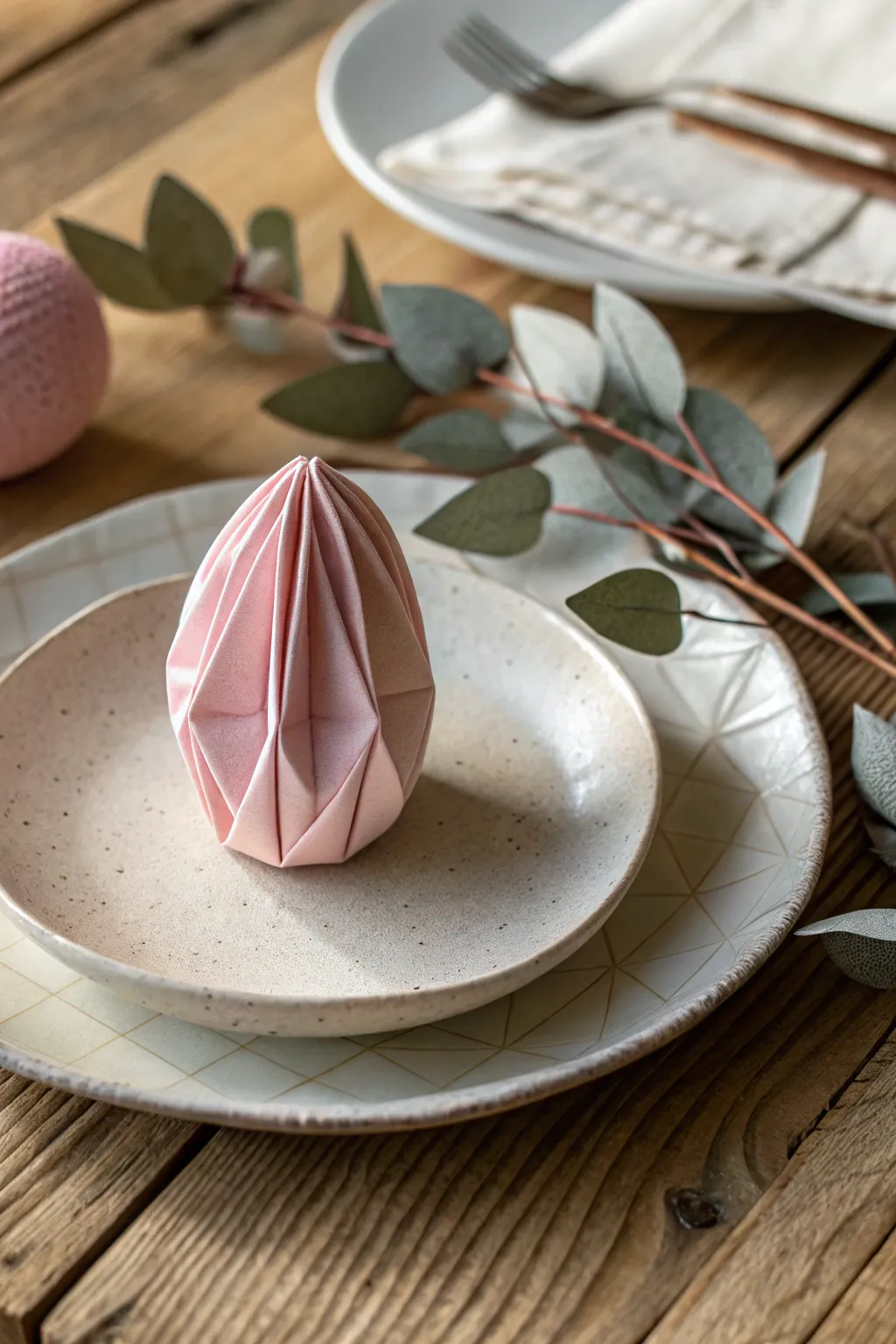 Elevate your Easter table with this charming egg-shaped napkin fold, a perfect blend of playful elegance and minimalist style.