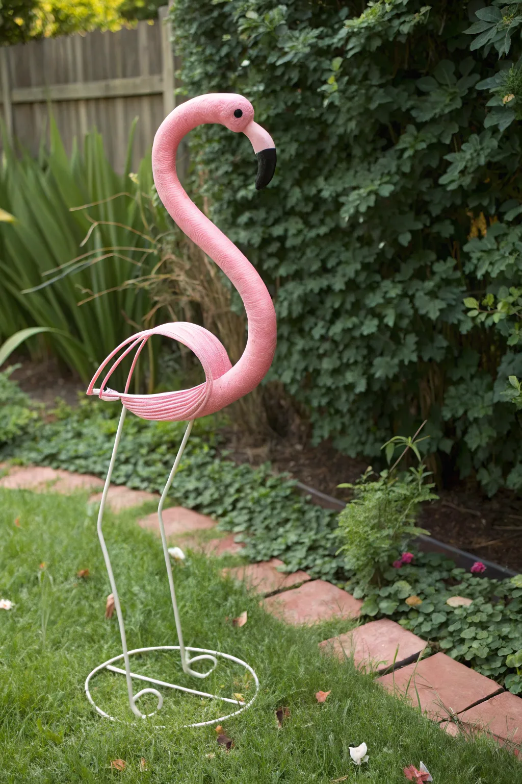 Whimsy meets elegance with this charming flamingo decor, a delightful surprise in any garden!