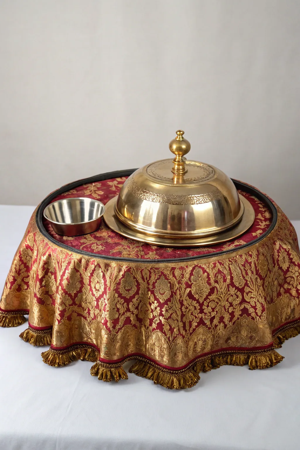 A thali covered in luxurious brocade, perfect for a regal setting.