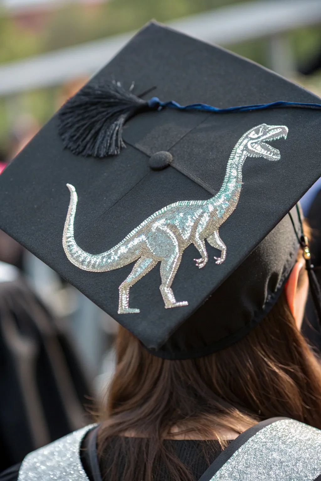 Elevate your graduation style with a metallic dino cap—where sophistication meets playful creativity.
