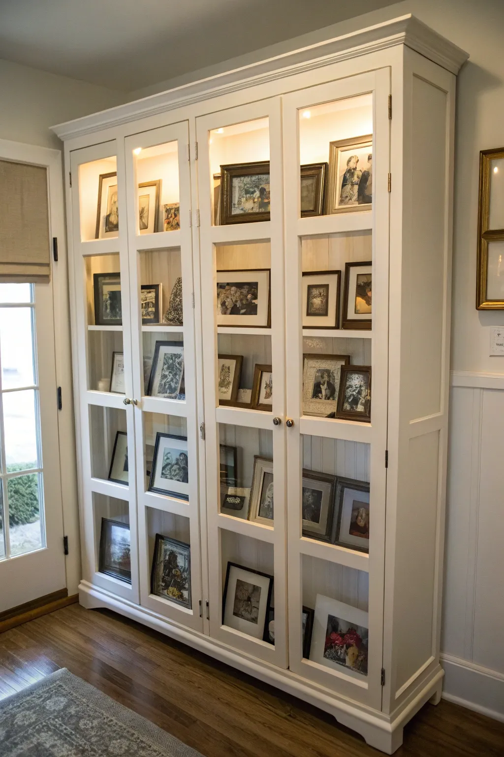 Personal photographs adding warmth to an armoire.