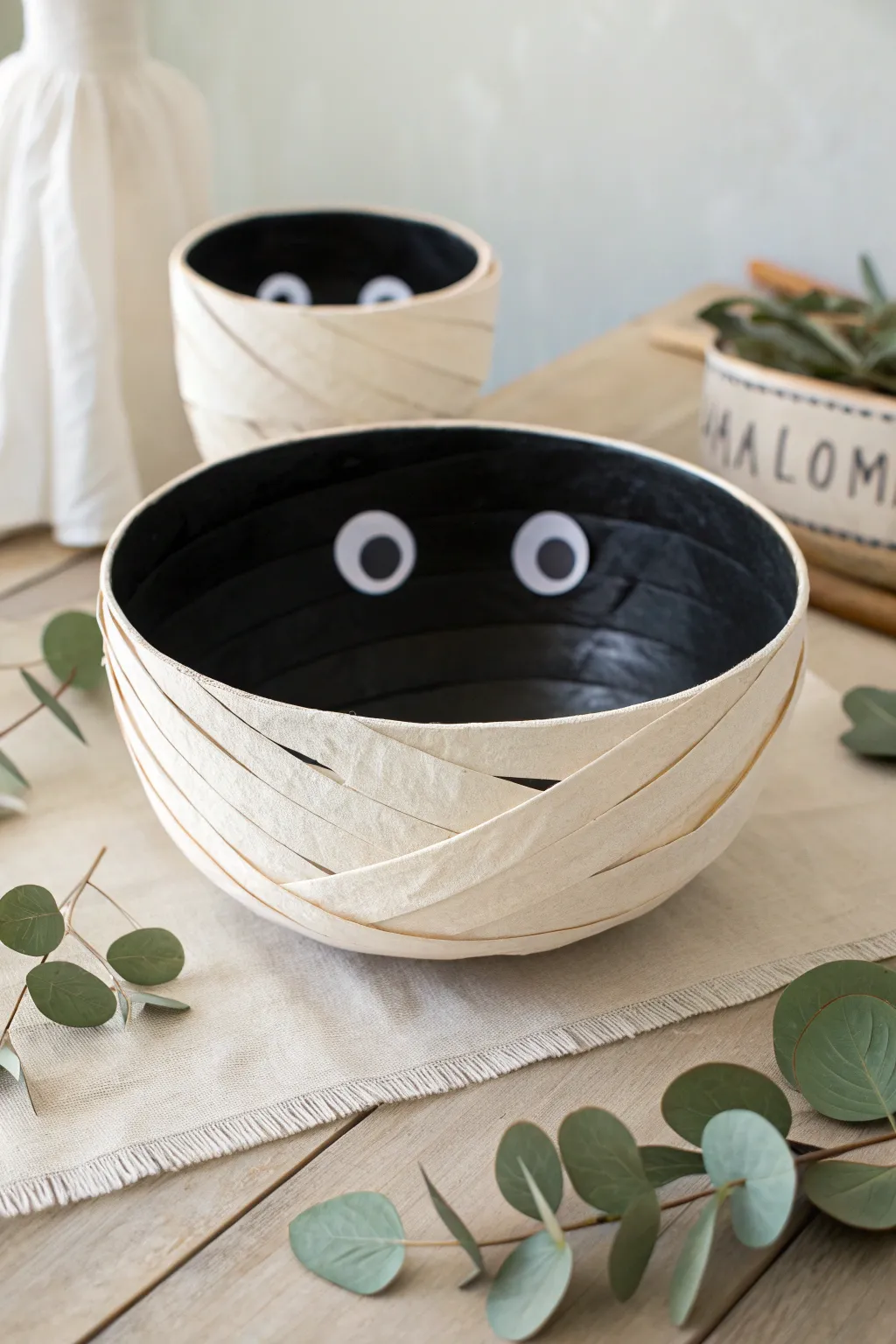 Embrace the art of minimalist Halloween crafts with this charming 3D paper bowl mummy. Perfect for adding a touch of playful spookiness to your decor!