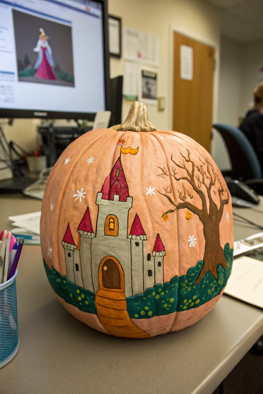 A fanciful fairy tale castle pumpkin, enchanting the office with its storybook charm.