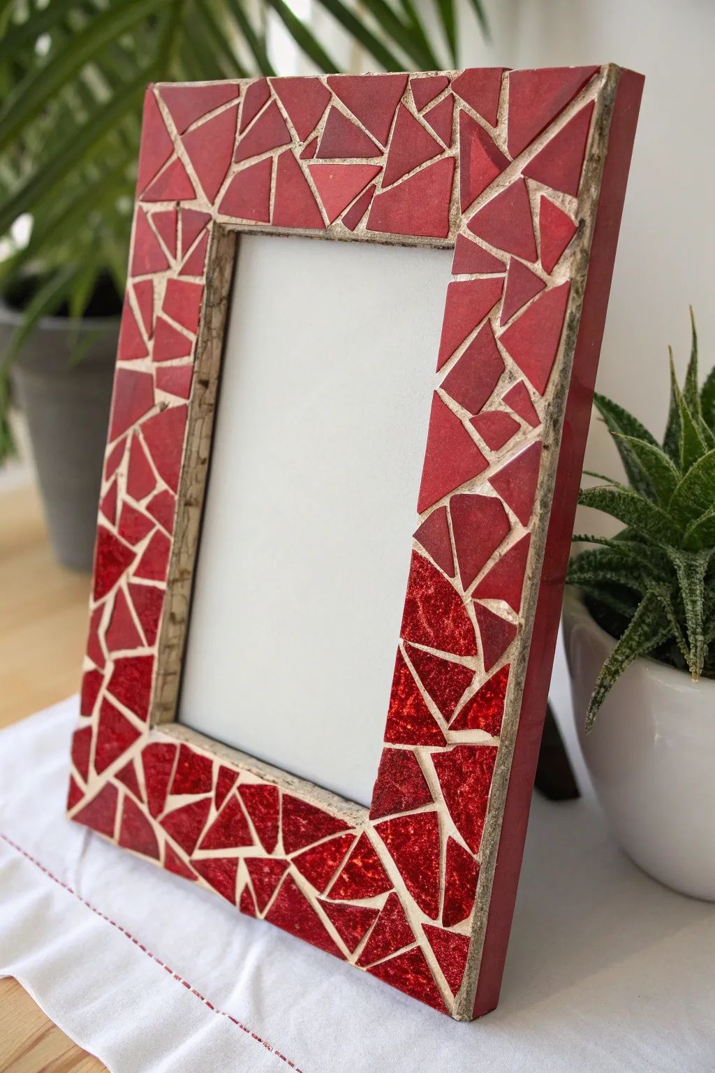 Transform your memories with a touch of artistry using a handmade red mosaic picture frame.