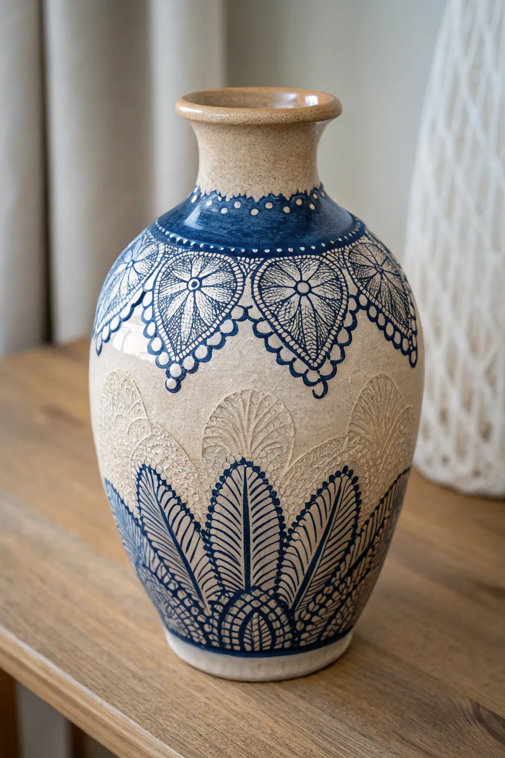 Add a touch of vintage elegance to your decor with this lace-imprinted ceramic vase.