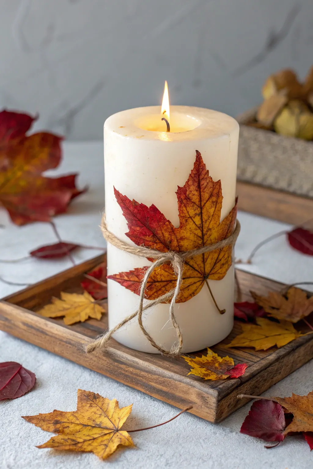 Embrace the cozy essence of autumn with this leaf-adorned candle centerpiece.