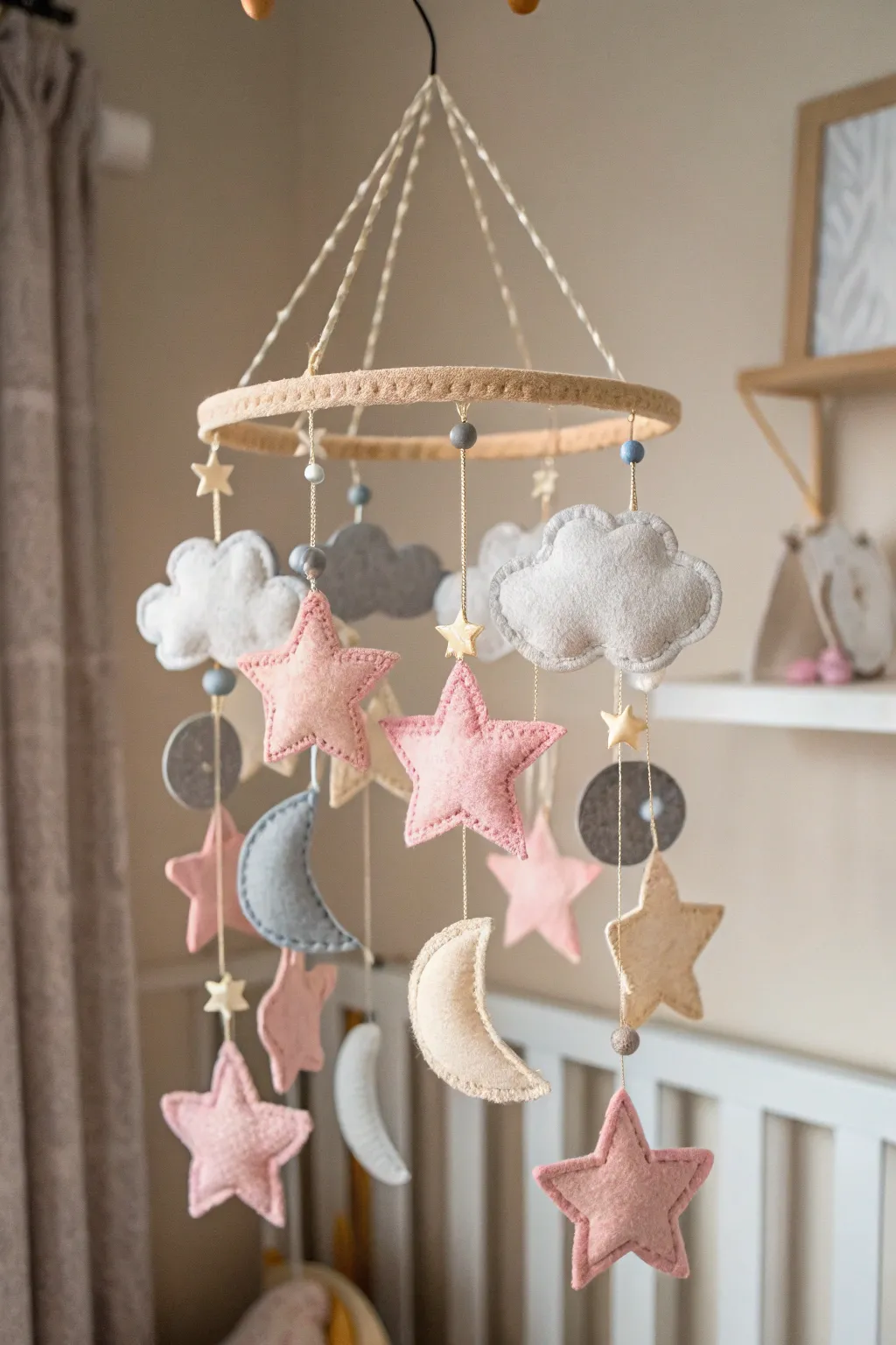 Transform your nursery into a serene haven with this charming felt mobile, where craftsmanship meets minimalistic beauty.