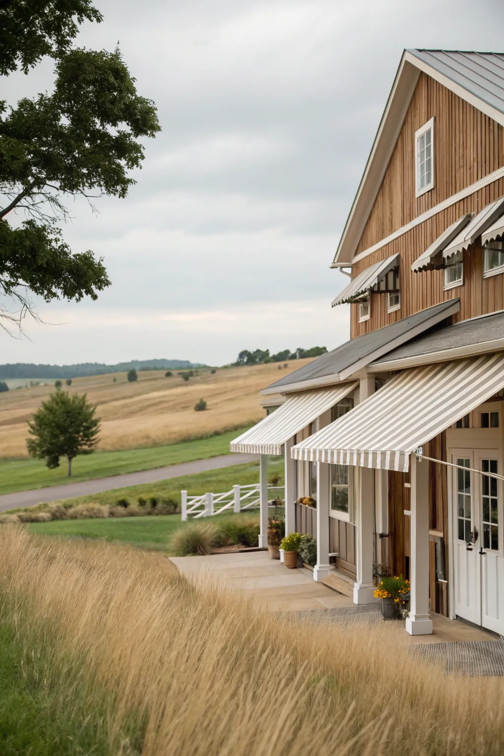 Barn-inspired awnings bring rustic charm to this farmhouse setting.
