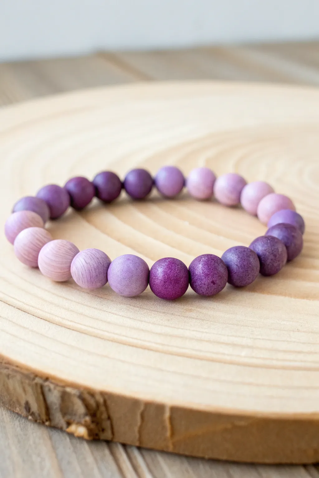 Embrace the art of symmetry with this minimalist purple clay bead bracelet, where simplicity meets natural beauty.