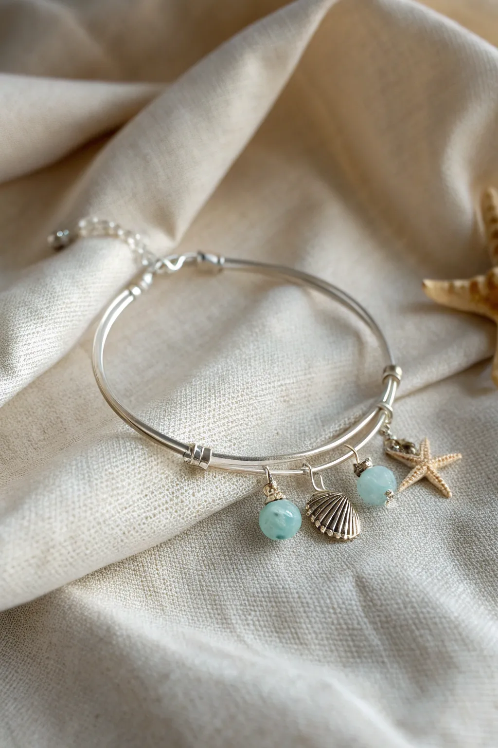 Embrace coastal elegance with this seaside-themed wire bracelet, where minimalism meets natural beauty.