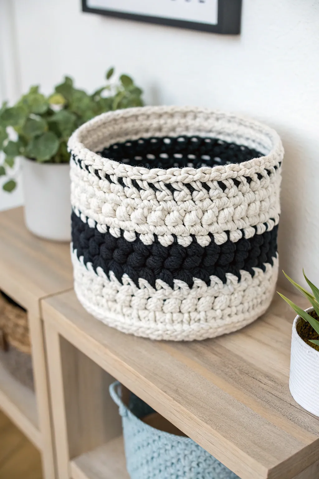 Elevate your space with this chic black and white crochet basket, a perfect blend of style and function.