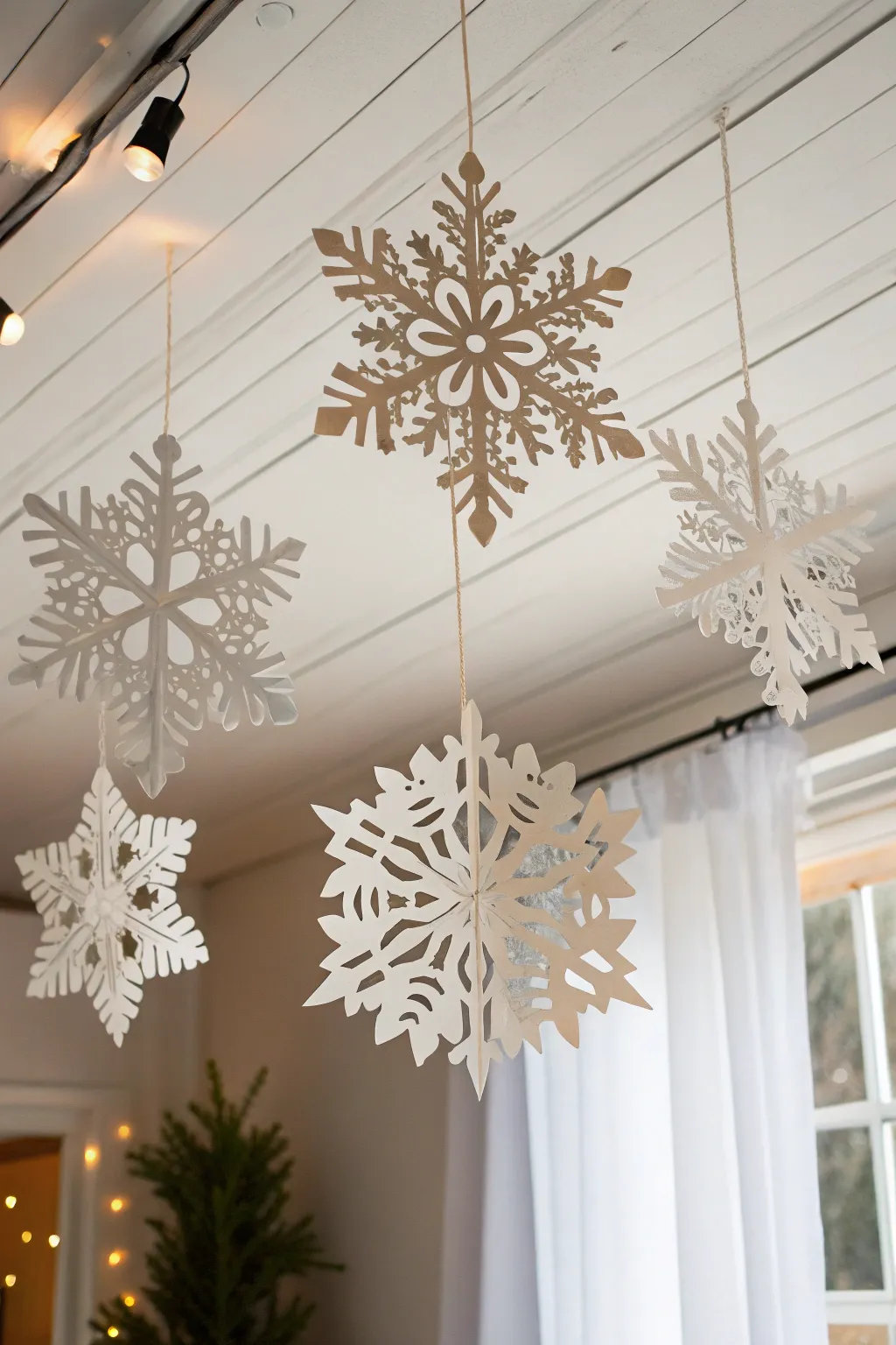 Transform your space into a winter wonderland with handcrafted paper snowflakes, adding a touch of minimalist elegance to your holiday decor.