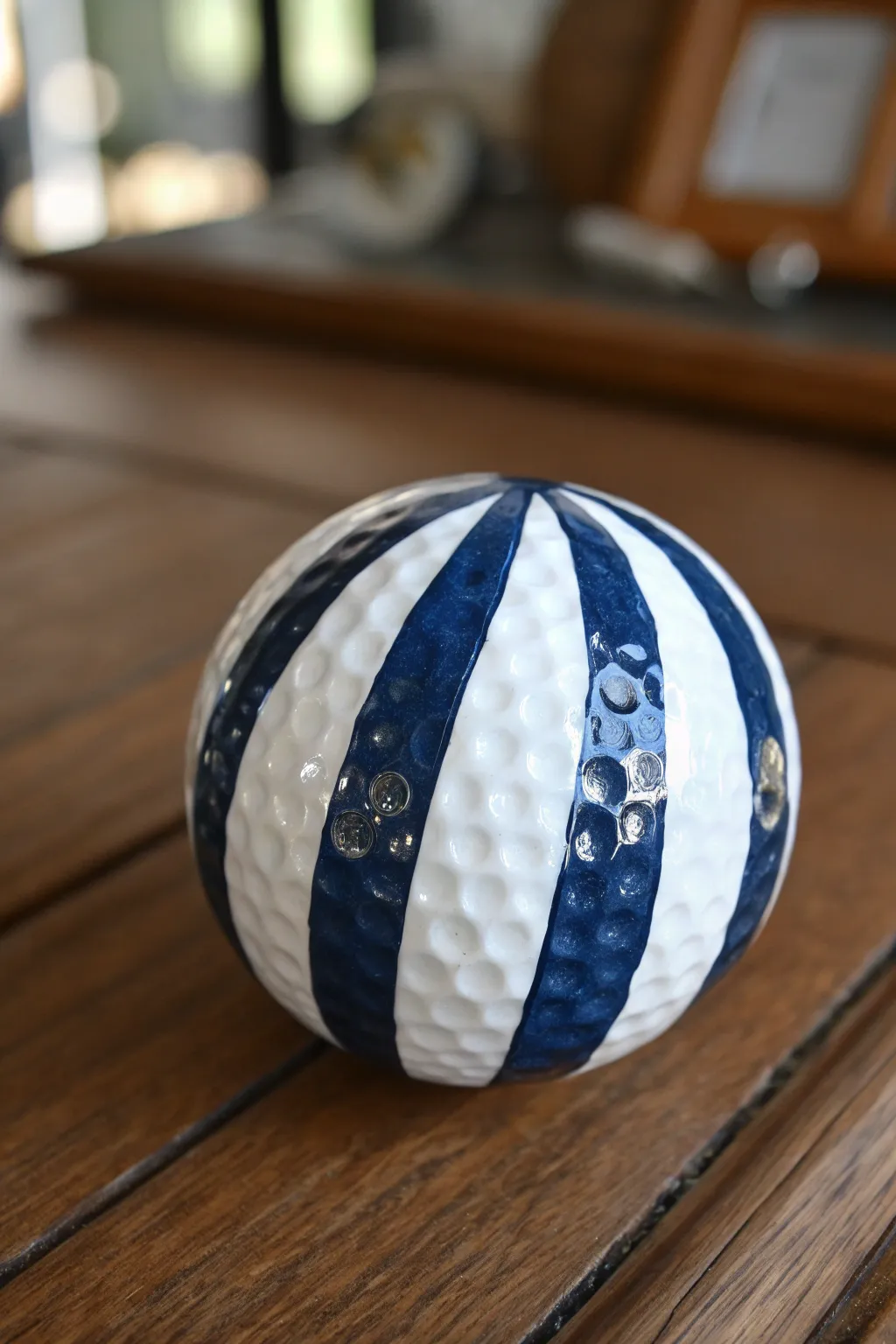 Embrace the charm of striped elegance with this handcrafted golf ball design.