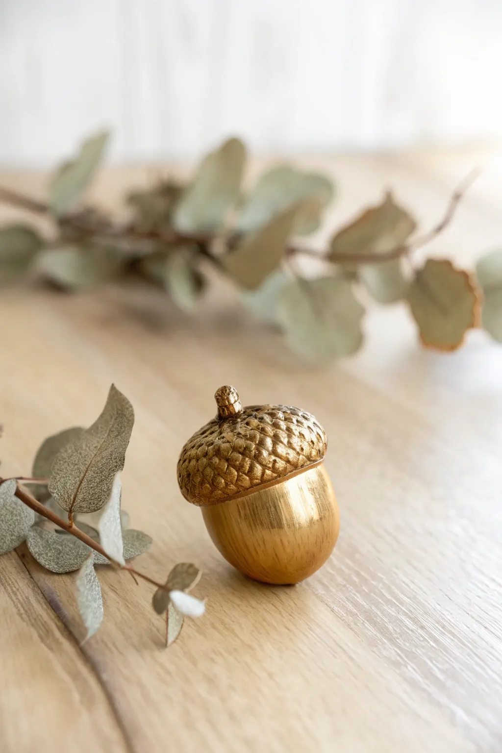 Add a touch of metallic magic to your decor with shimmering gold acorns.