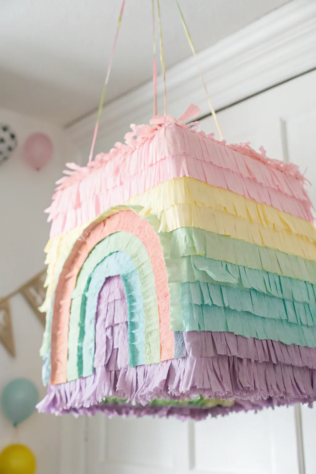 Add a splash of pastel magic to your celebration with this handcrafted rainbow piñata!