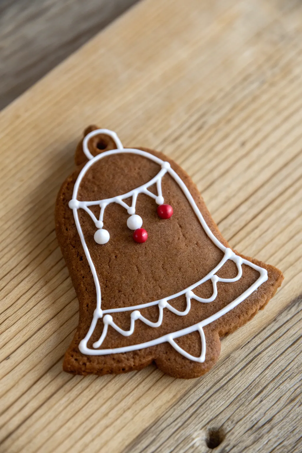 Embrace the cozy magic of the season with a rustic gingerbread bell cookie, perfectly crafted for a minimalist holiday delight.
