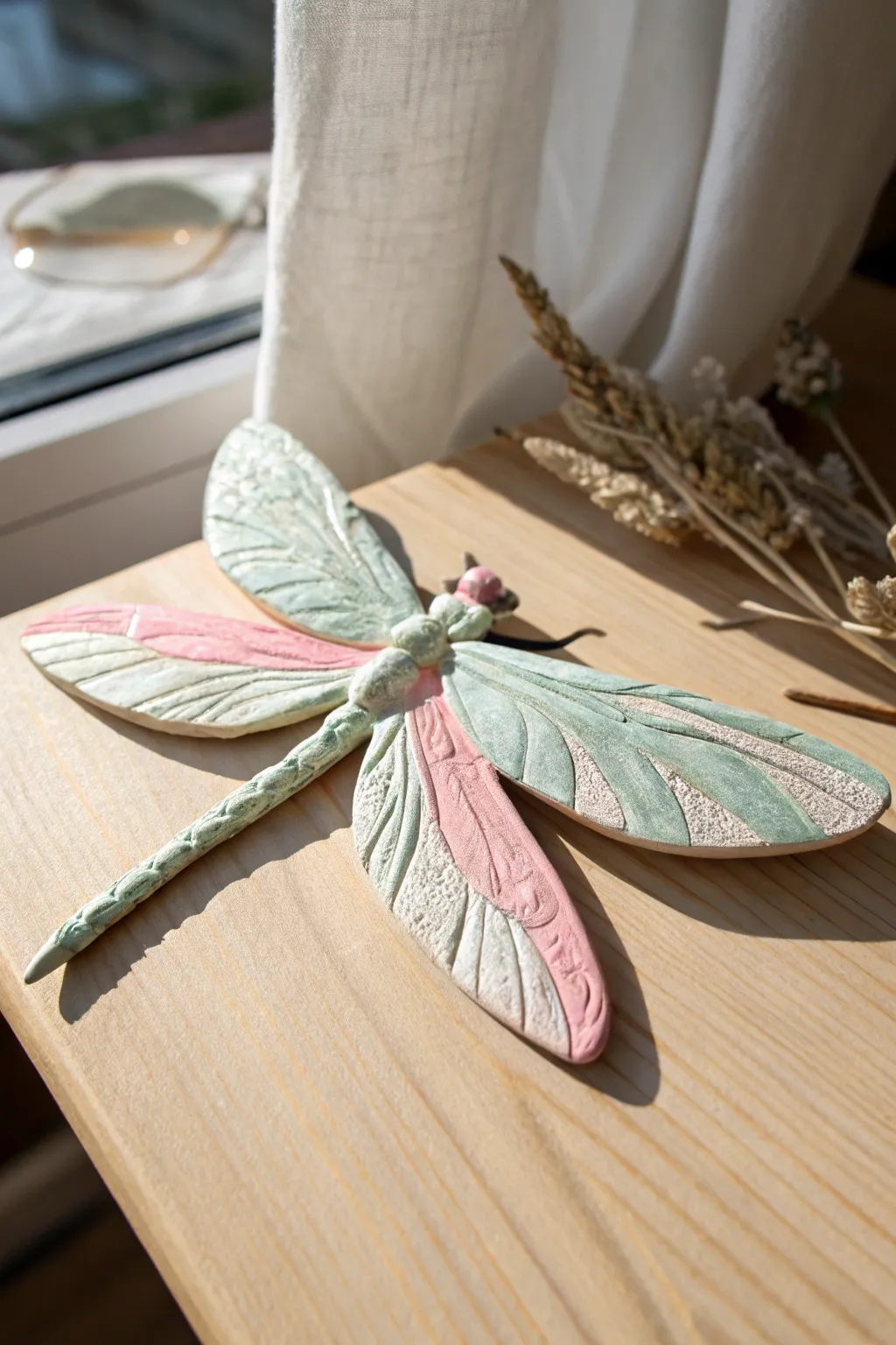 Bring a touch of whimsy to your home with this handcrafted clay dragonfly sculpture.