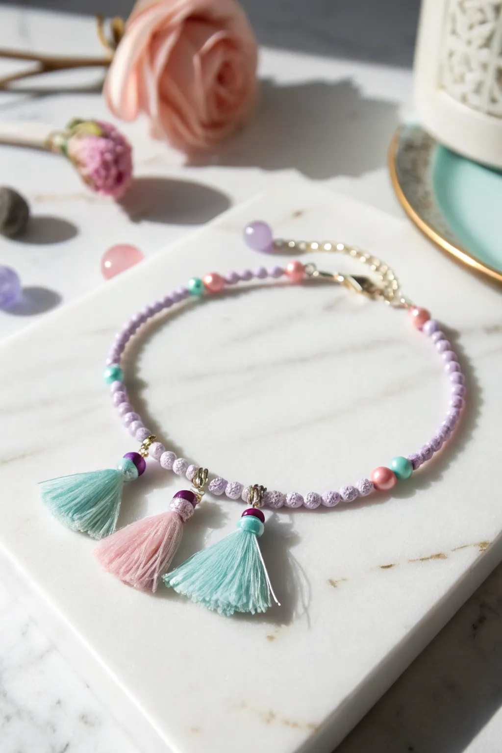 Add a playful touch to your wrist with a tassel and pom-pom charm bracelet, perfect for any occasion!
