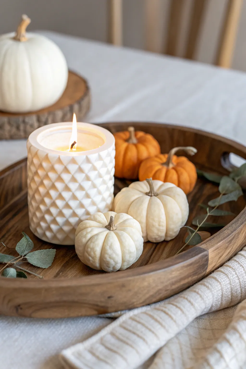Embrace the cozy elegance of candles and pumpkins in perfect harmony.