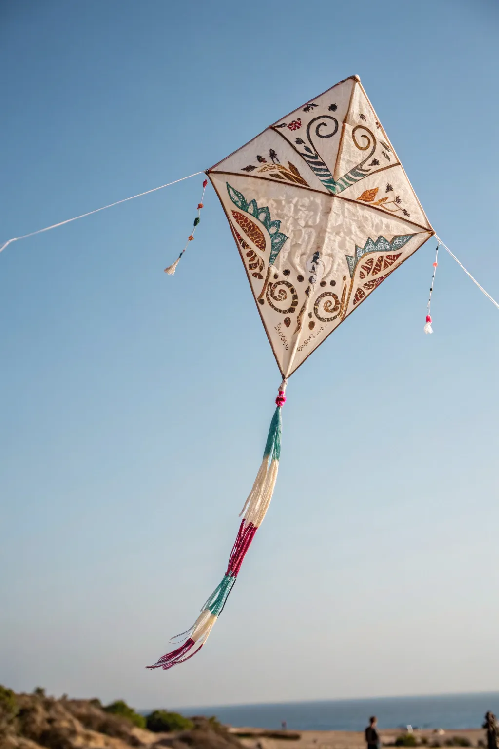 Timeless elegance in the sky: A classic diamond-shaped kite with a boho twist.