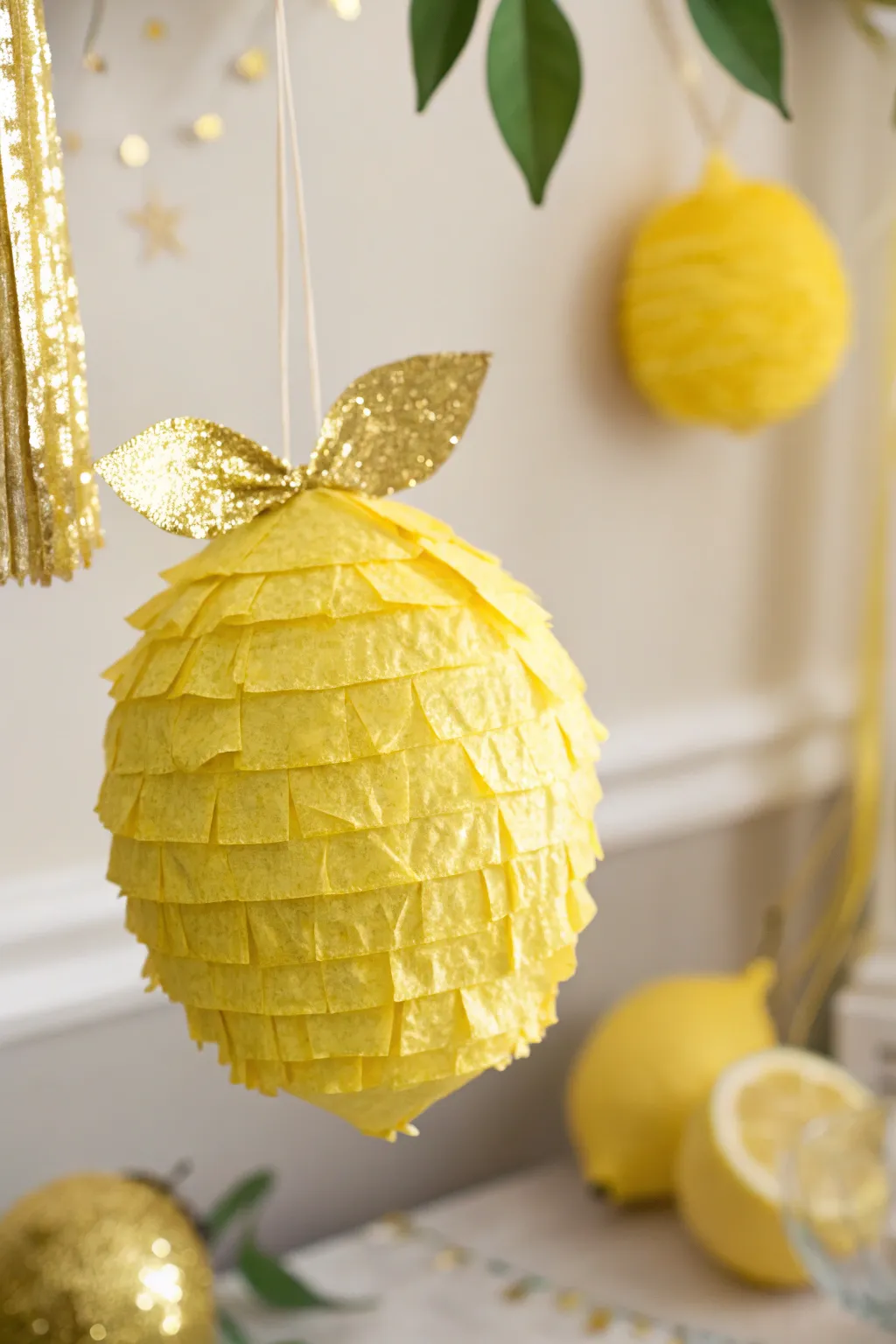 Add a zest of sunshine to your space with this charming lemon pinata, where minimalist design meets boho sparkle.