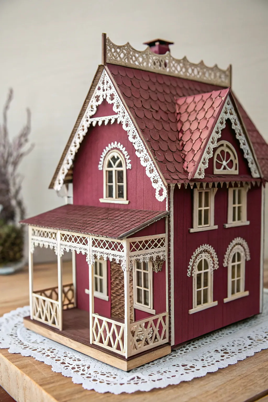 Discover the elegance of a Victorian-style paper house with intricate lace-like details.