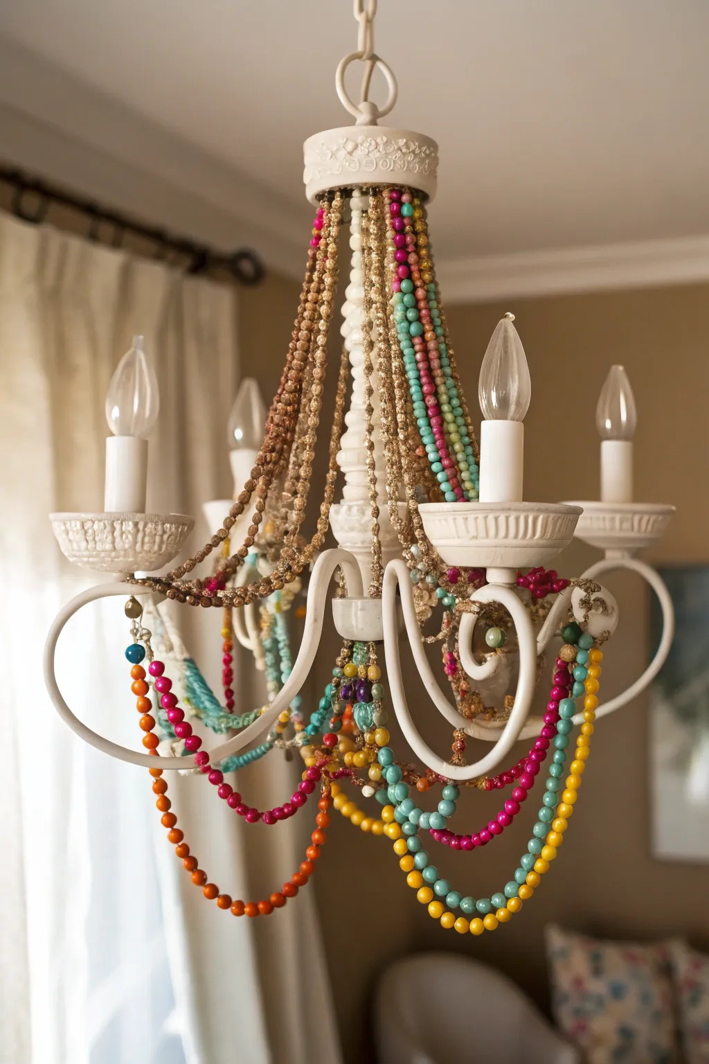 Elevate your space with a touch of boho chic: a vibrant bead-wrapped chandelier transformation.