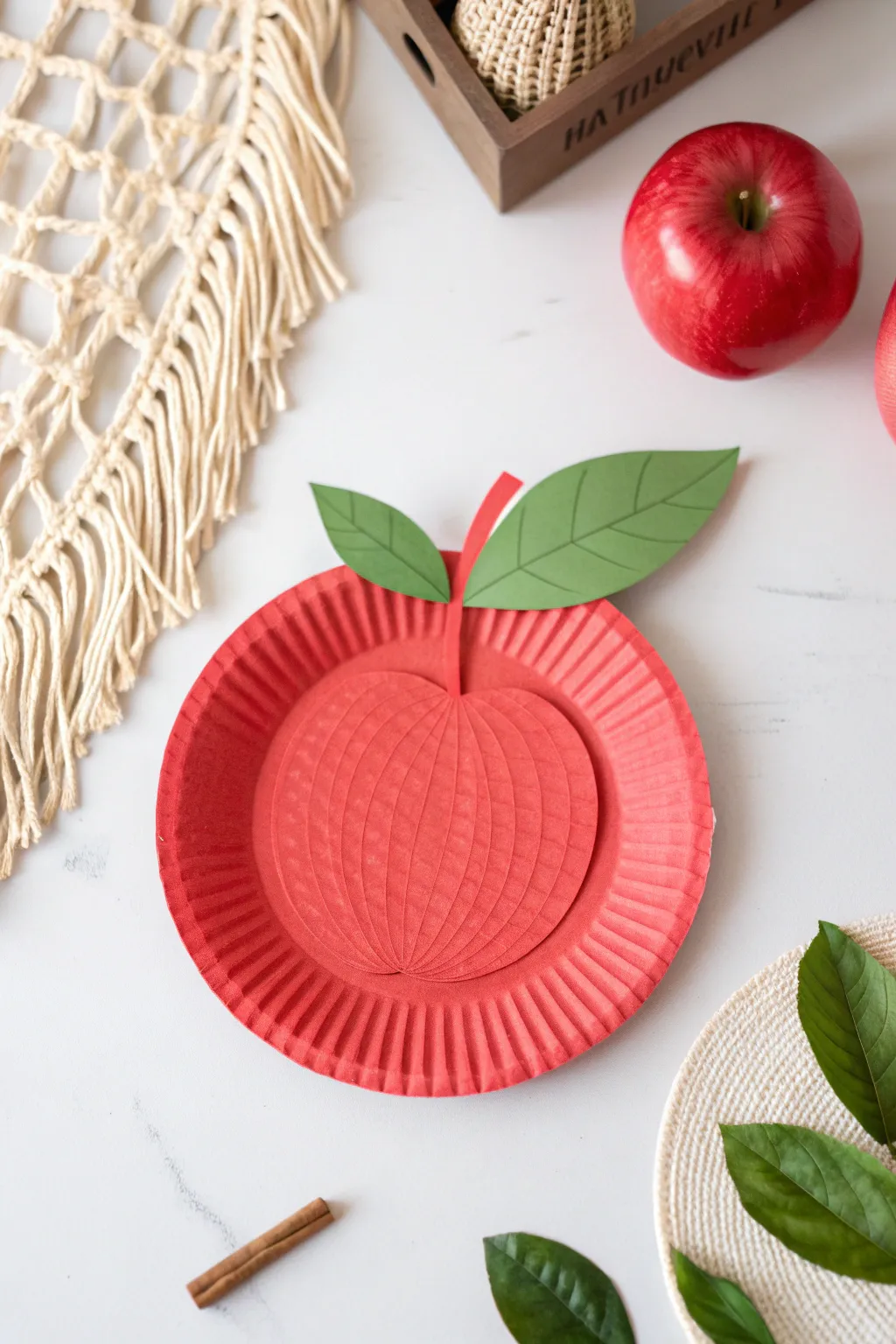 Transform simple materials into charming paper plate apples that bring a touch of creativity to any space!