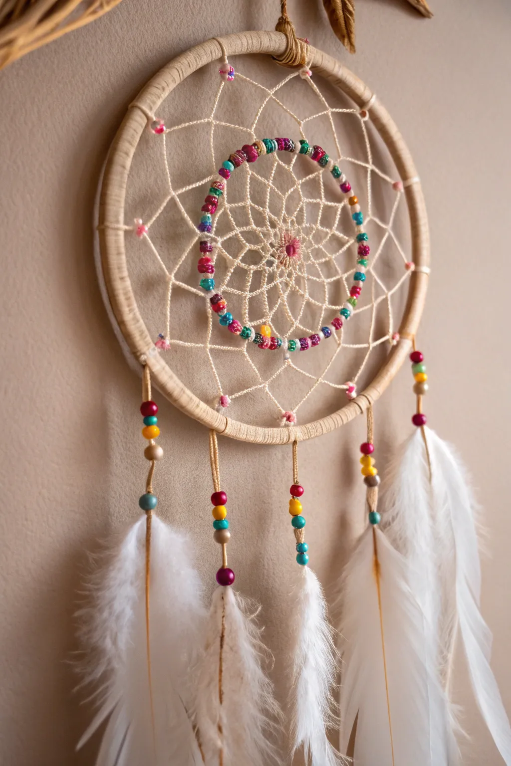 Add a touch of boho elegance to your space with this handcrafted dream catcher, where vibrant beads meet minimalist charm.