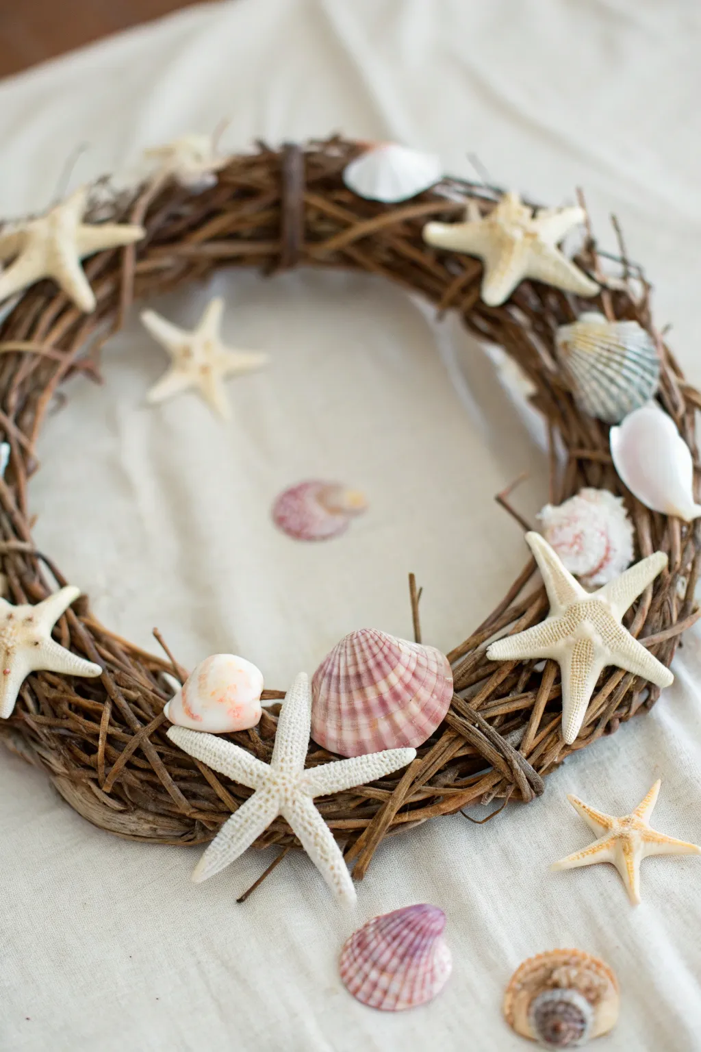 Embrace coastal charm with this starfish adorned wreath, a perfect touch of seaside serenity for your home.