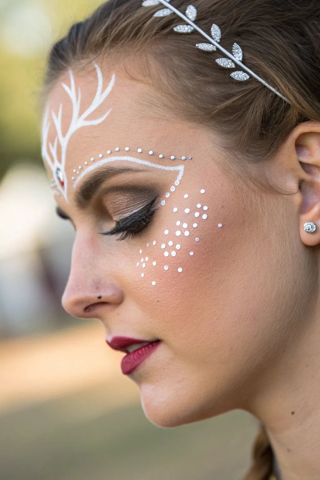 Sparkle like a star with enchanting rhinestone deer face paint.