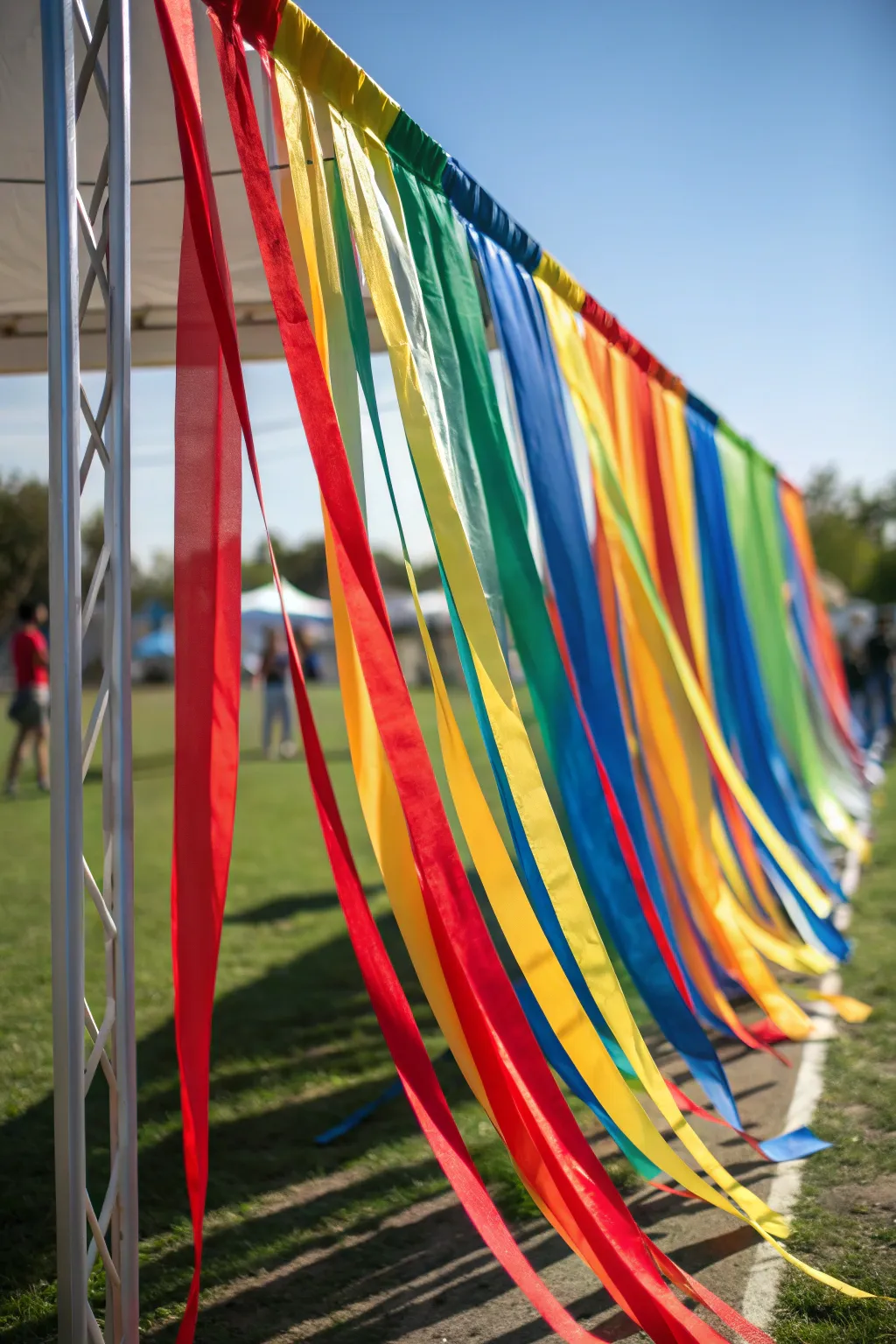 Burst through the colorful streamer curtain and finish in style! #DIYFinishLine #Craftsmanship #VibrantVictory