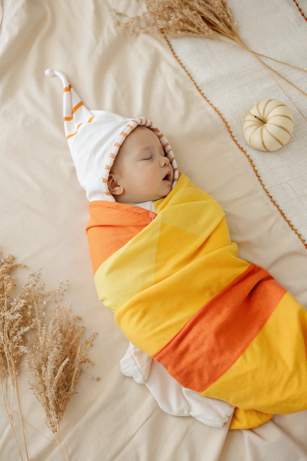 Sweet as candy corn: Capture the essence of playfulness and warmth in this adorable DIY Halloween baby photoshoot.