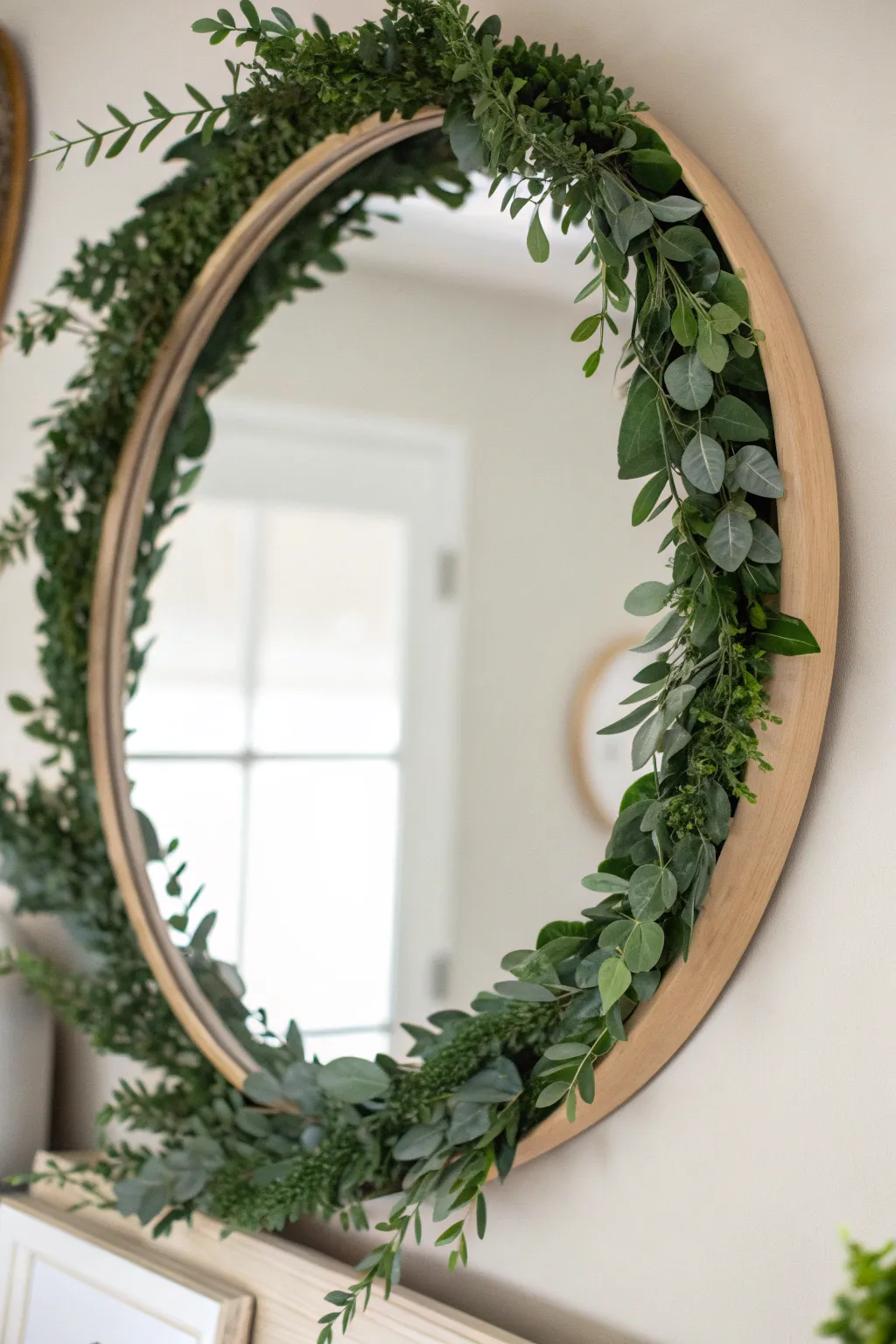 Elevate your space with a touch of nature - a simple greenery garland transforms any mirror into a stunning centerpiece.