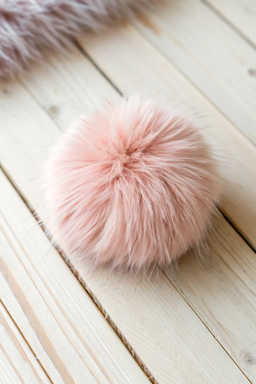Add a touch of whimsy to your winter with these charming DIY faux fur pom-poms!