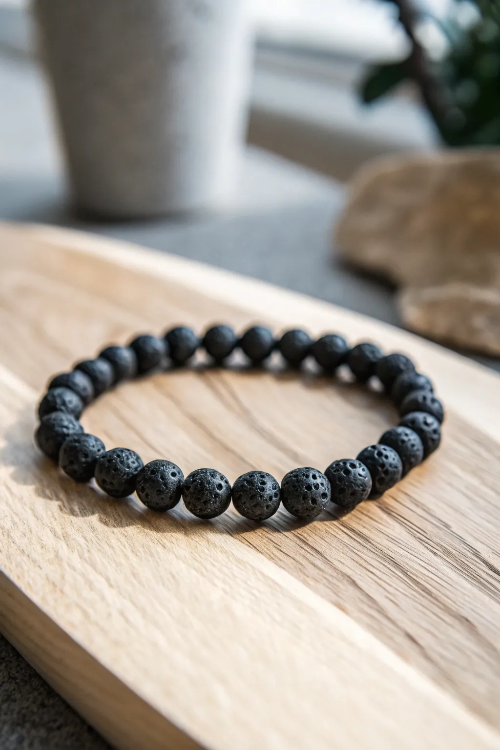 Embrace minimalism with a bold statement: the allure of a monochrome lava bead bracelet.