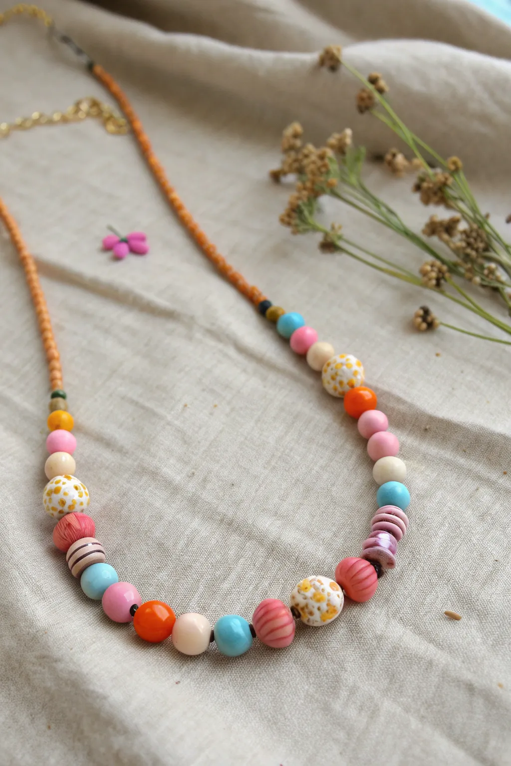 Embrace the charm of asymmetry with this bold and beautiful pony bead necklace.